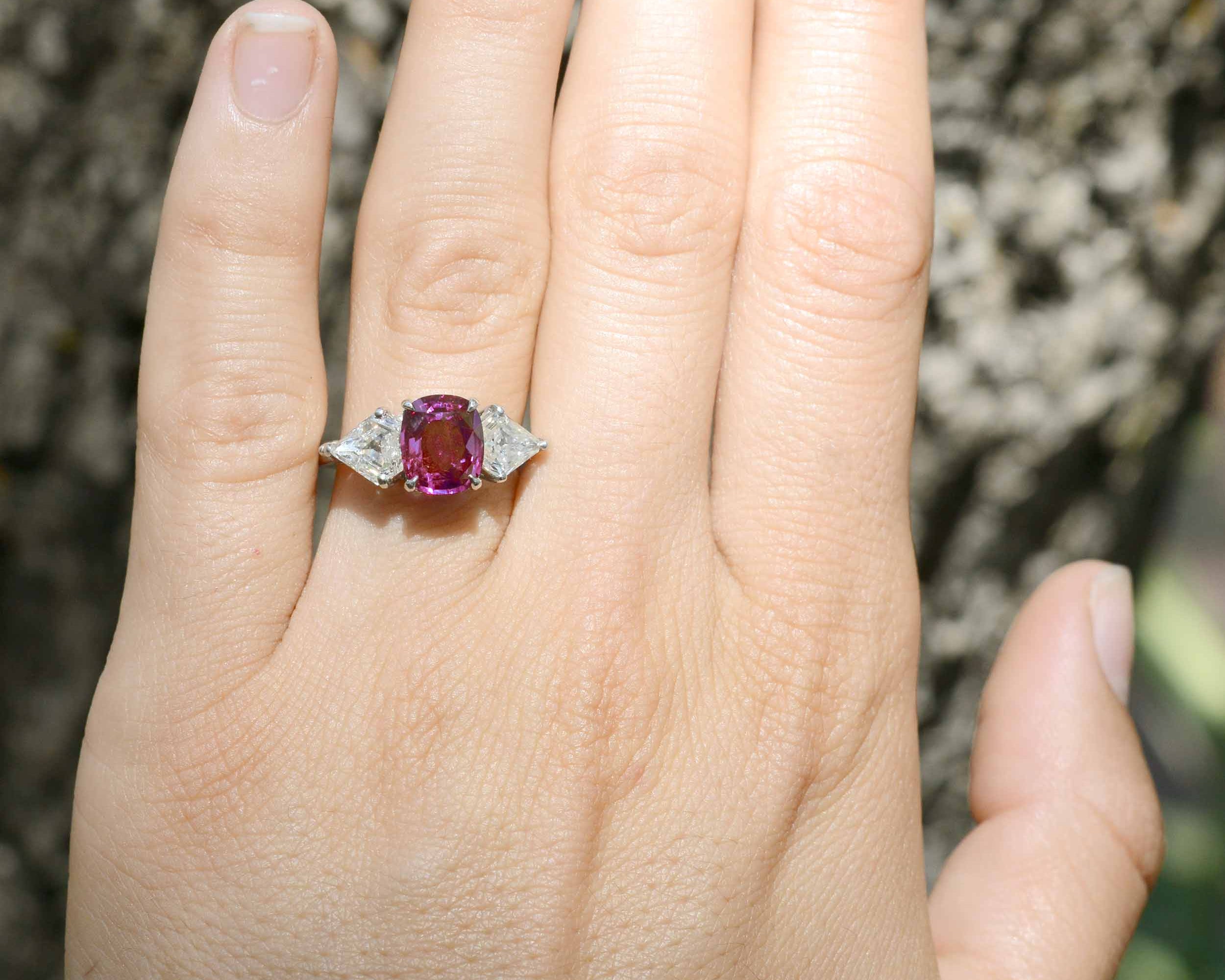This unique, cushion cut purple pink sapphire has great transparency.