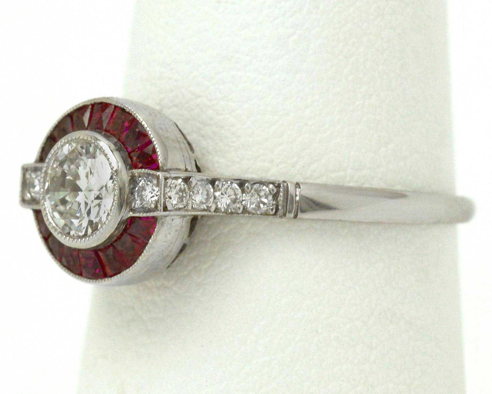 An old European brilliant diamond set in a ruby target Art Deco wedding ring design.