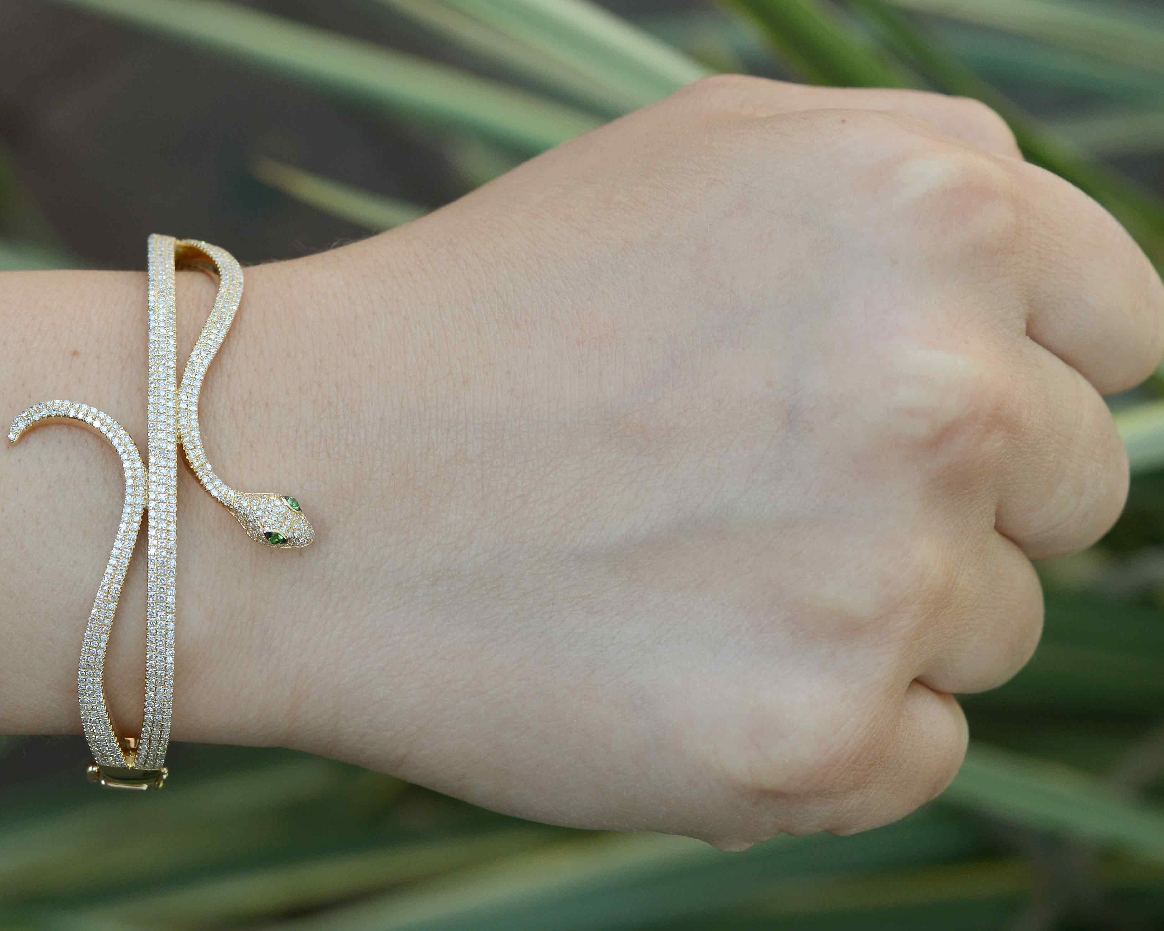A gold Egyptian revival bracelet styled as a serpent bangle.