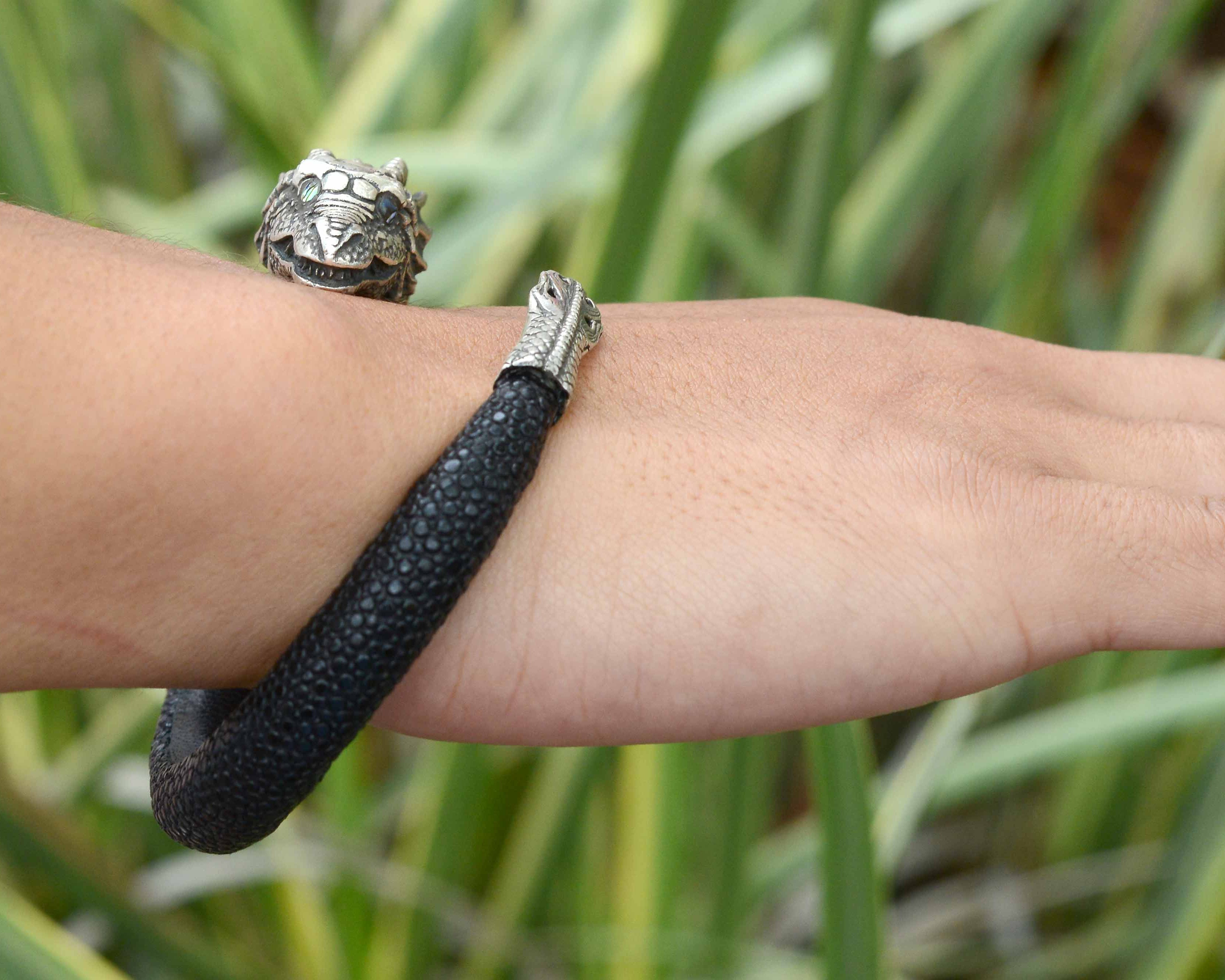 A gothic revival vibe silver dragon bracelet wraps your arm.