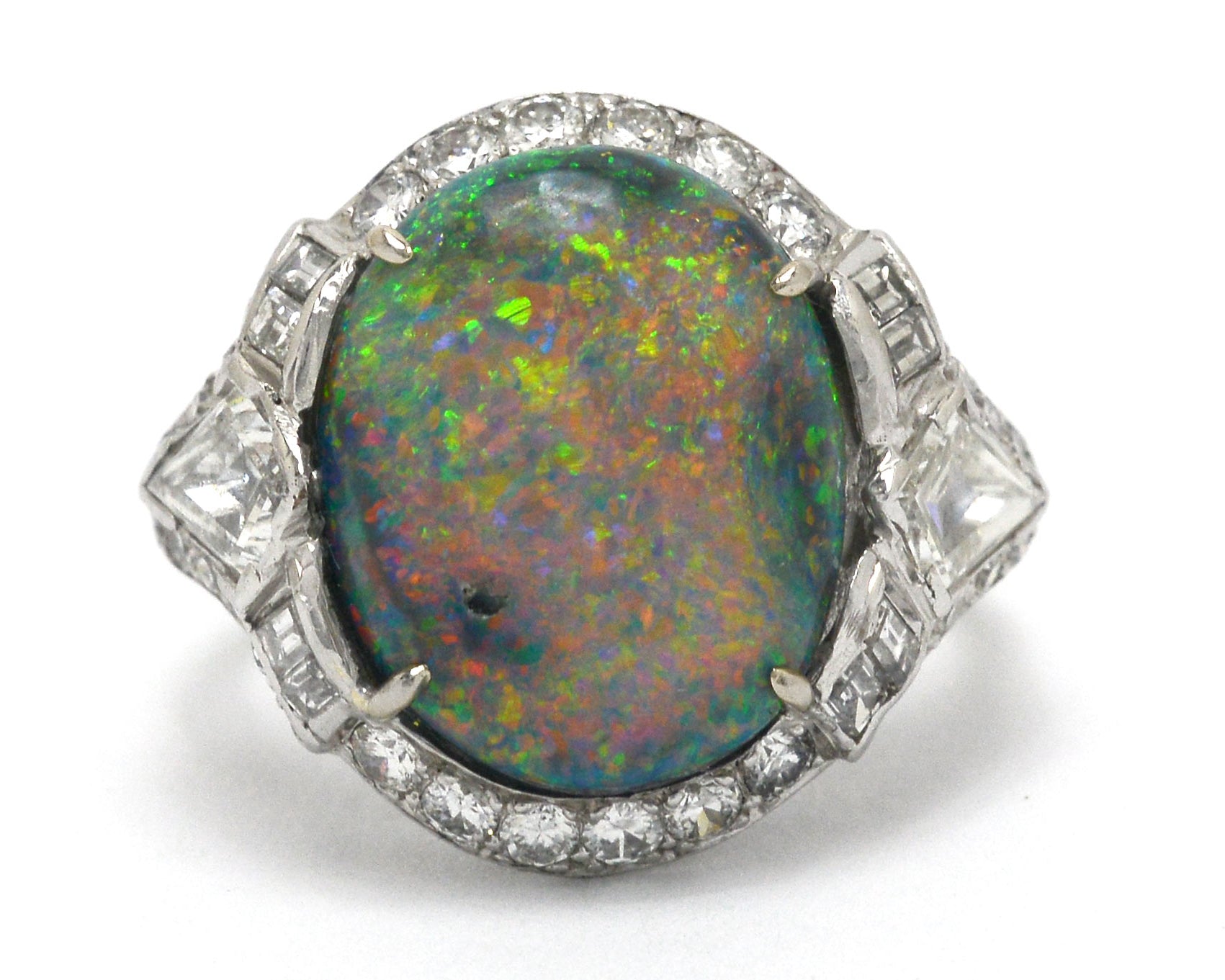 A large black opal set in a diamond halo, Art Deco dome ring.