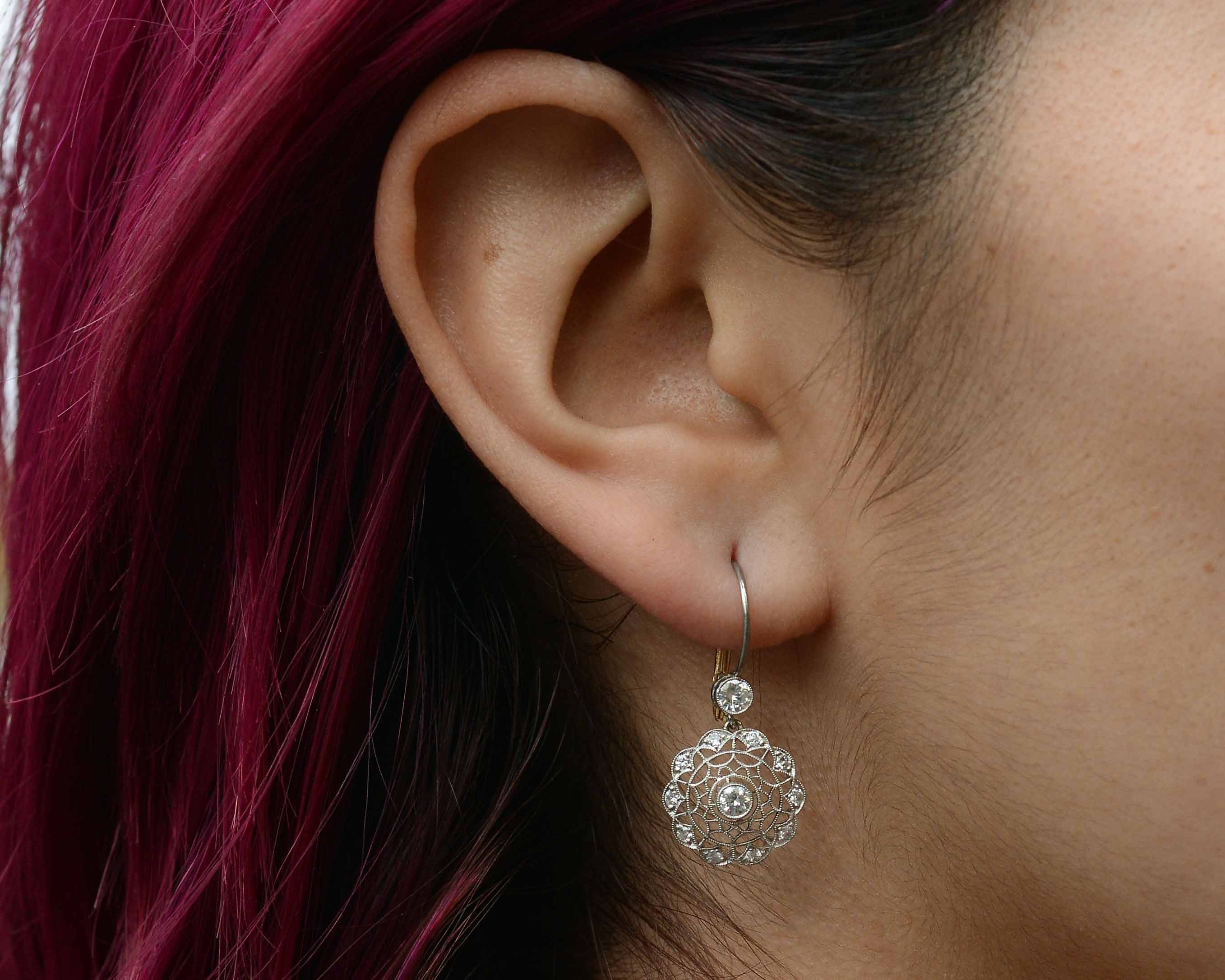 These diamond cluster earrings resemble a spider web.