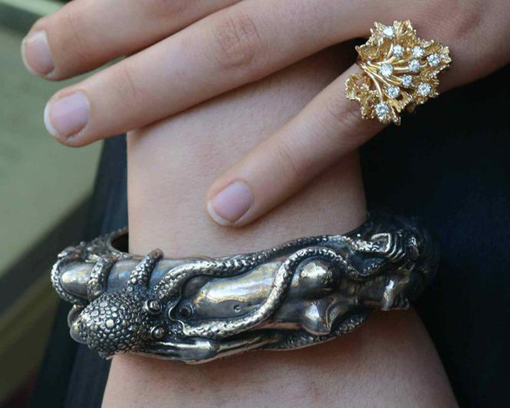 This nude woman silver bracelet design is based on the story, "the dream of the fisherman's wife".