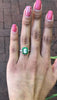 An Art Deco style emeralds and diamonds wedding ring.