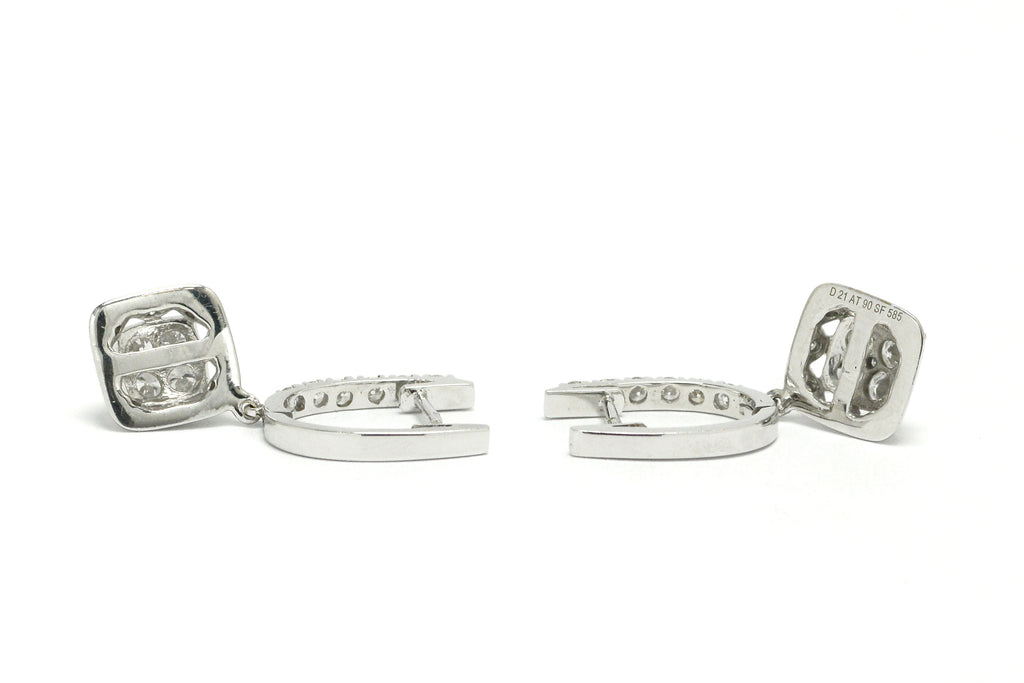 White gold horseshoe latch earrings lined with diamonds.