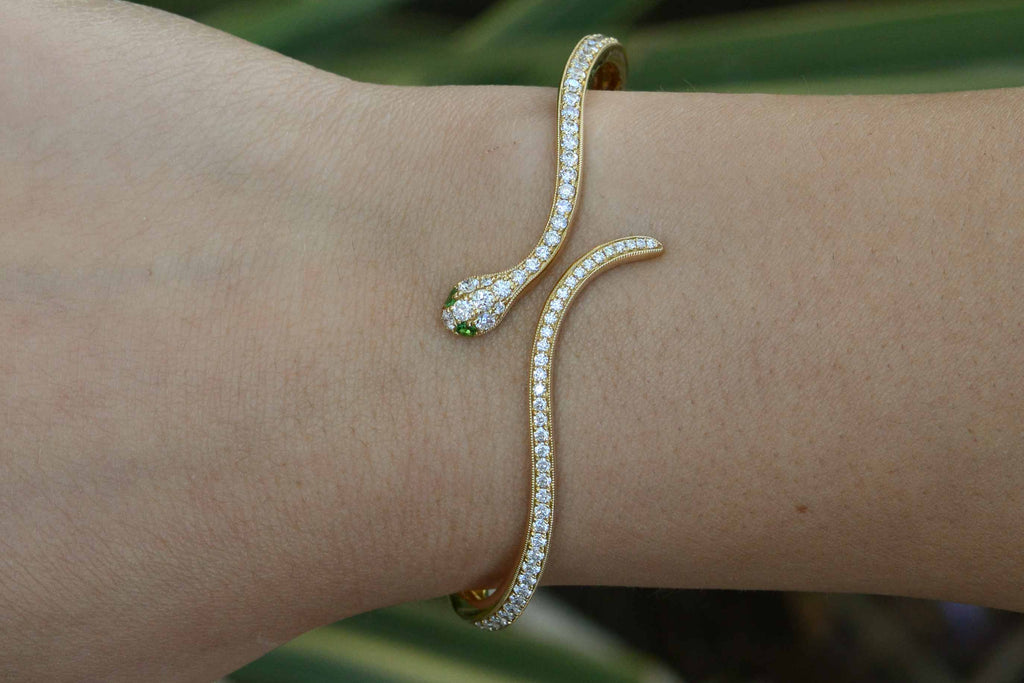 Nearly 1 and a half carats of round diamonds line this thin modern snake bracelet.
