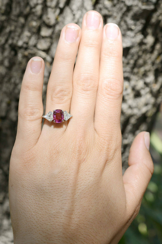 This unique, cushion cut purple pink sapphire has great transparency.