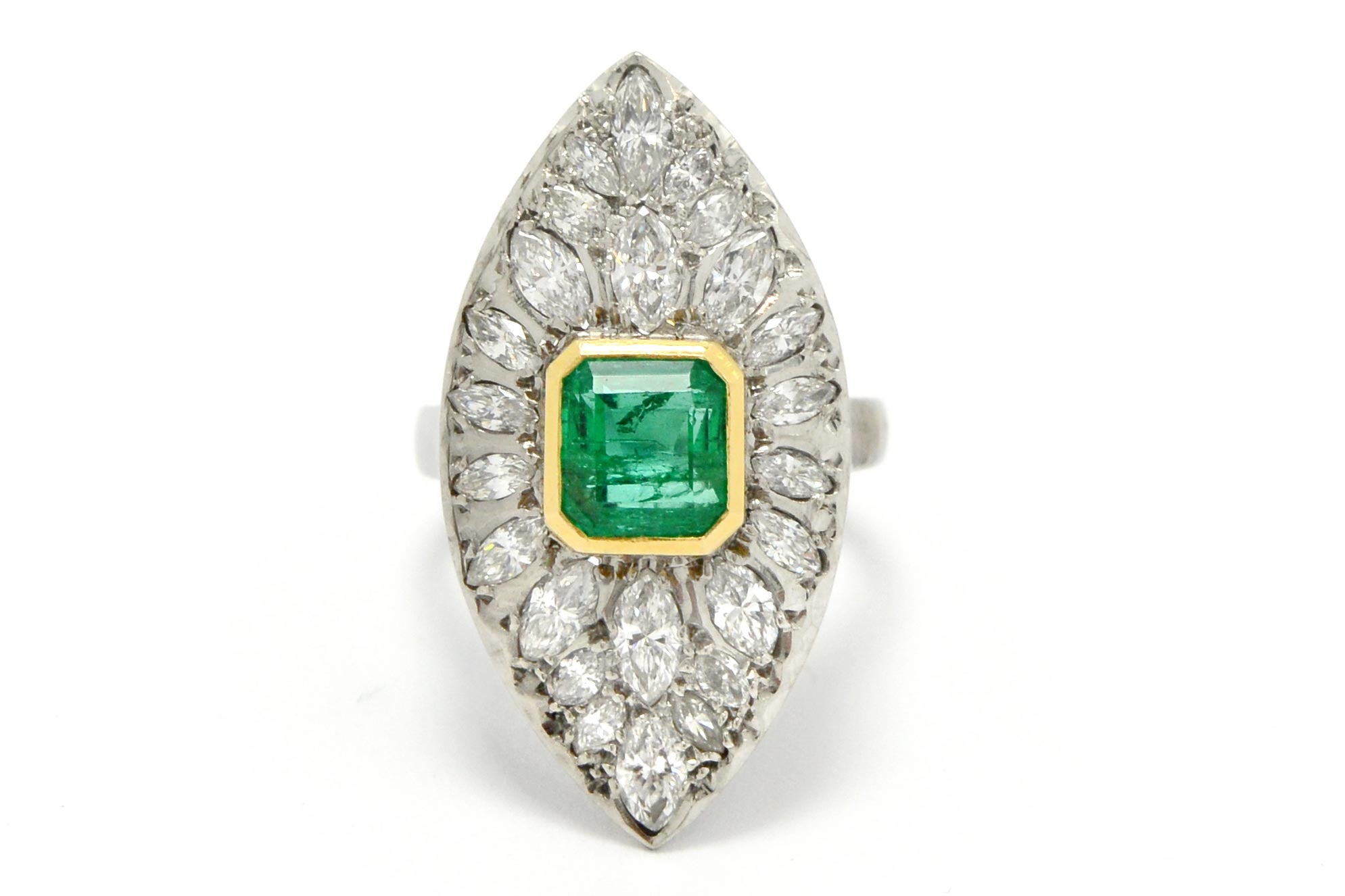 A stunning retro era estate cluster ring featuring a 2 carat Colombian emerald.