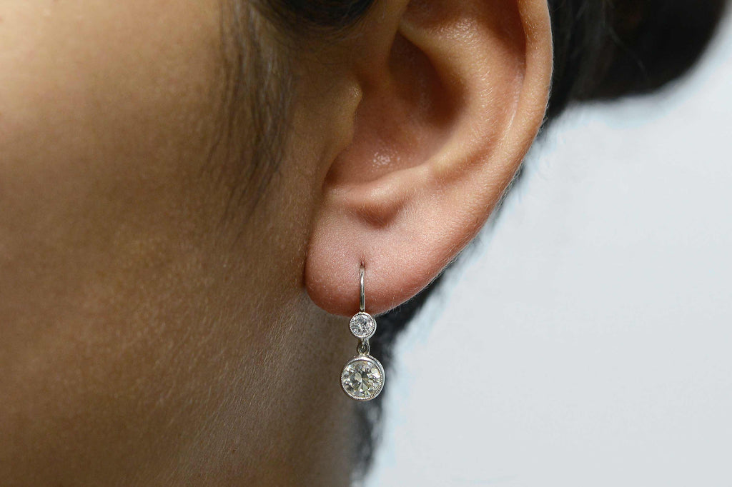Victorian revival, platinum antique drop earrings with 2 diamonds.