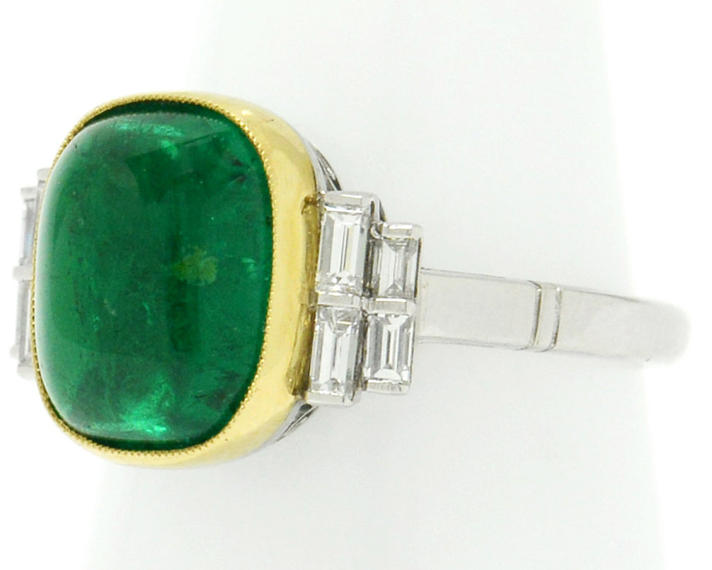 A new, platinum ring shank supports this large 4 carat emerald ring with 8 diamonds.