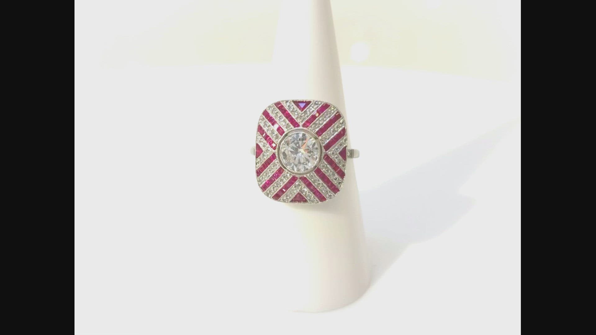 A rubies and diamonds platinum dome ring with a striped pattern. 