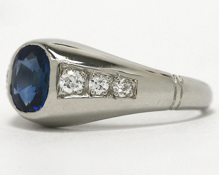A 1930s cushion cut sapphire ring with six accent diamonds.