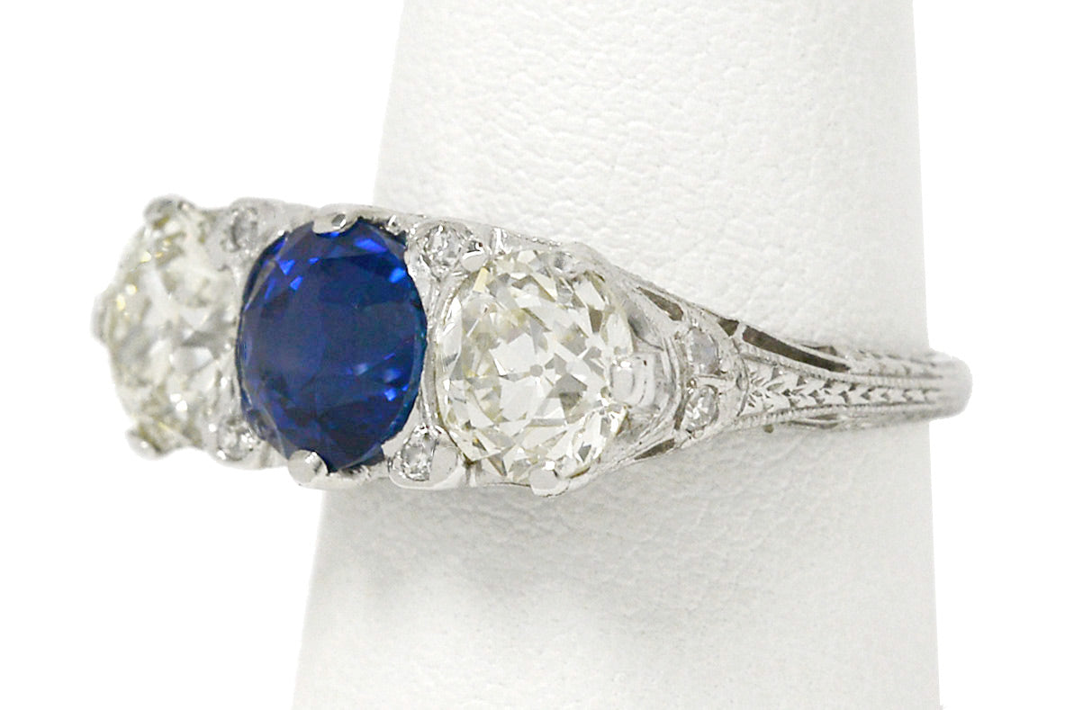 A platinum trinity 3 stone sapphire and diamonds engagement ring.