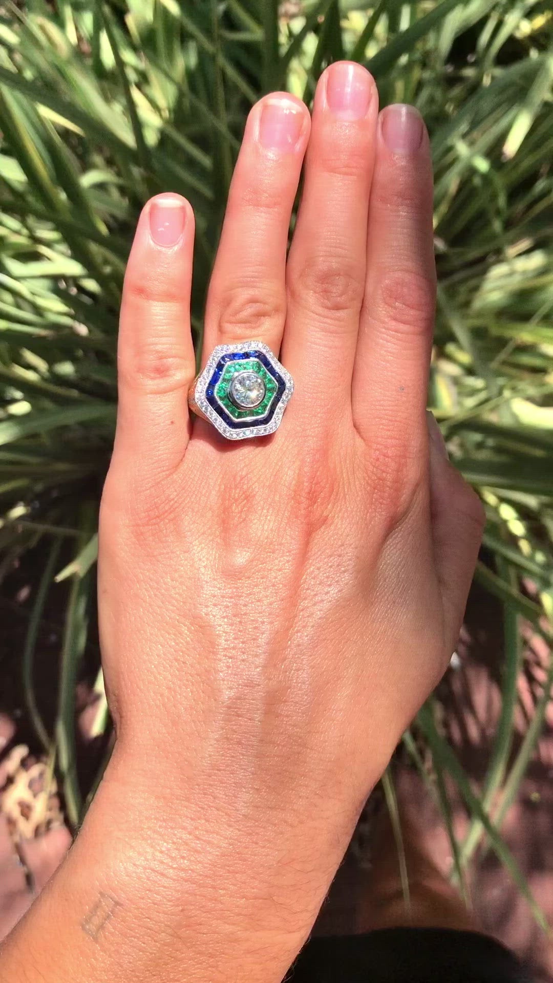 French & calibre' cut natural emeralds & sapphires accent this statement ring.