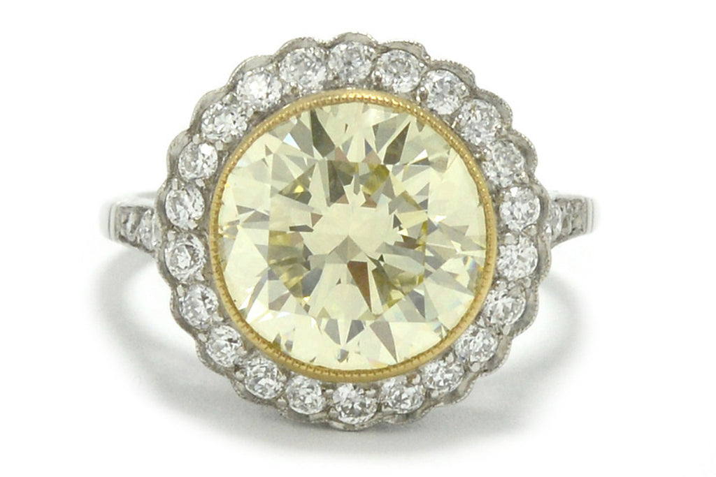 A nearly 5 carat yellow diamond halo engagement ring.