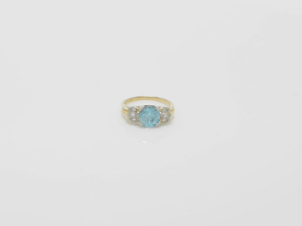 A 2 tone blue zircon 18k yellow and white gold engagement ring.