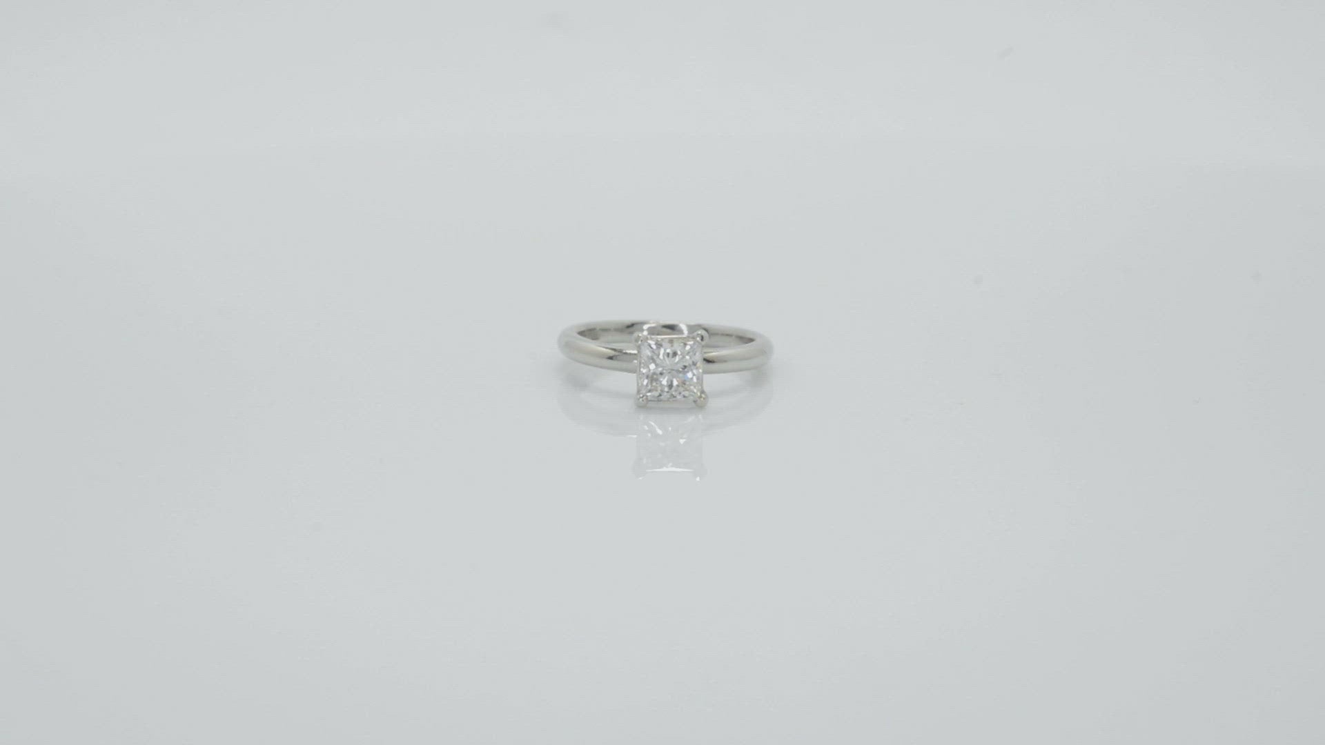 A modern platinum single diamond modern solitaire engagement ring.