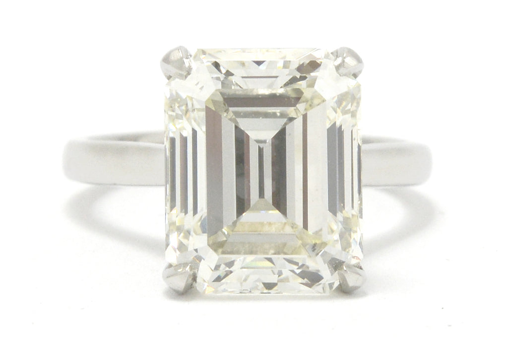 A large 8 carat emerald cut diamond solitaire engagement ring.