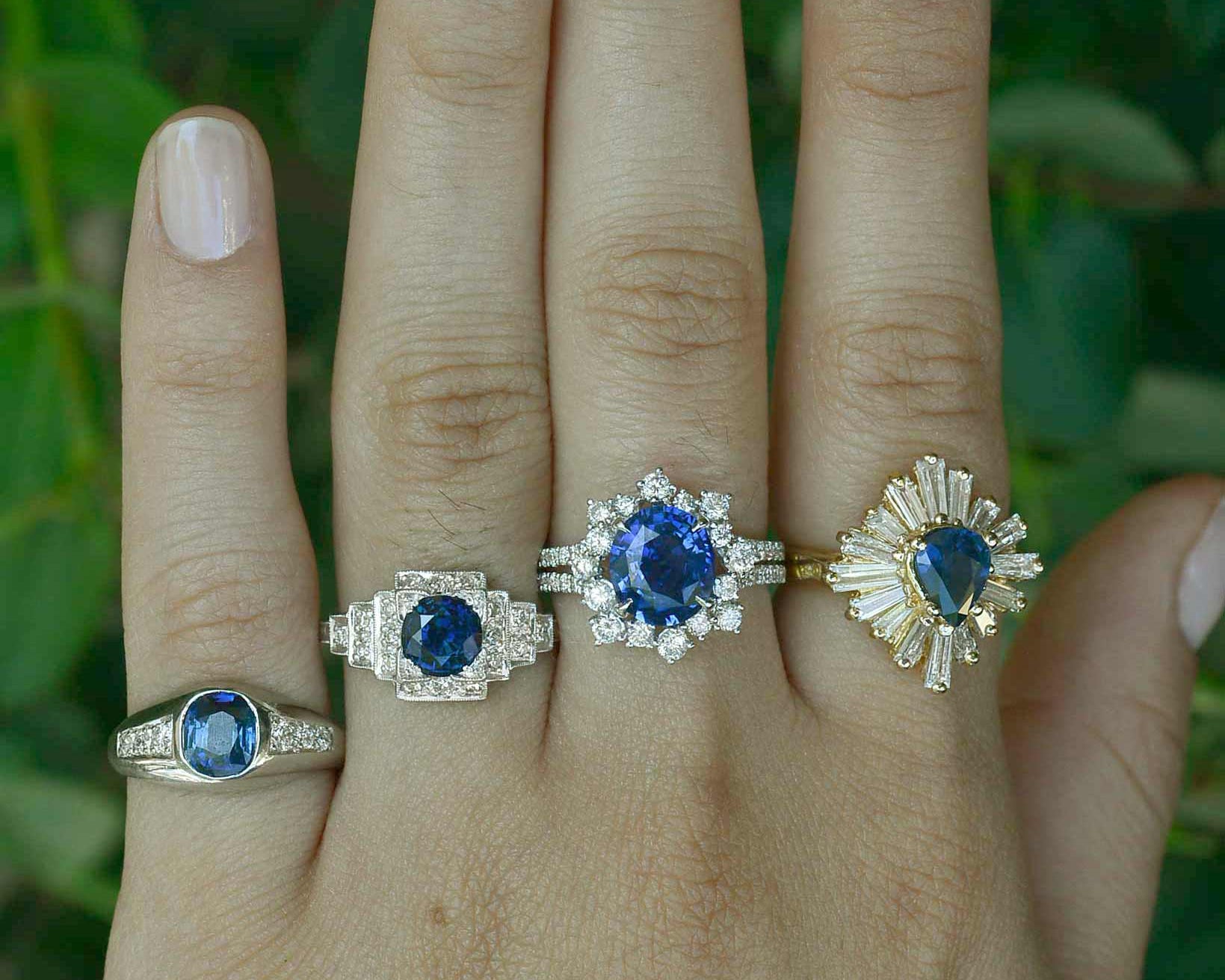 Round blue sapphire engagement rings with diamond halos.