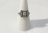 An Art Deco diamond wedding ring with black enamel.