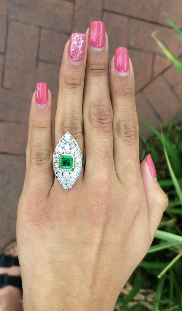 A large 2 carat emerald and marquise cut diamonds statement ring.