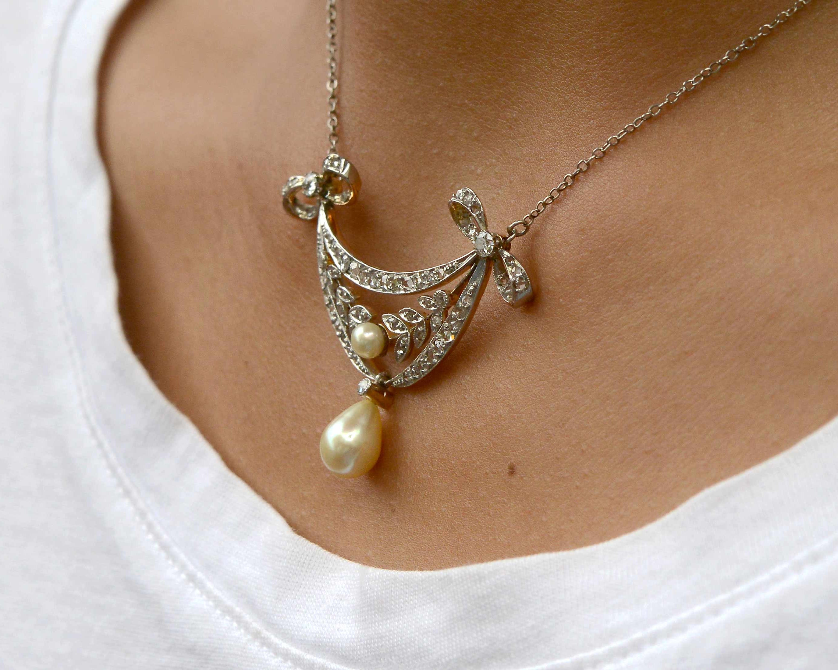 An antique diamonds drop lavalier necklace with two pearls.