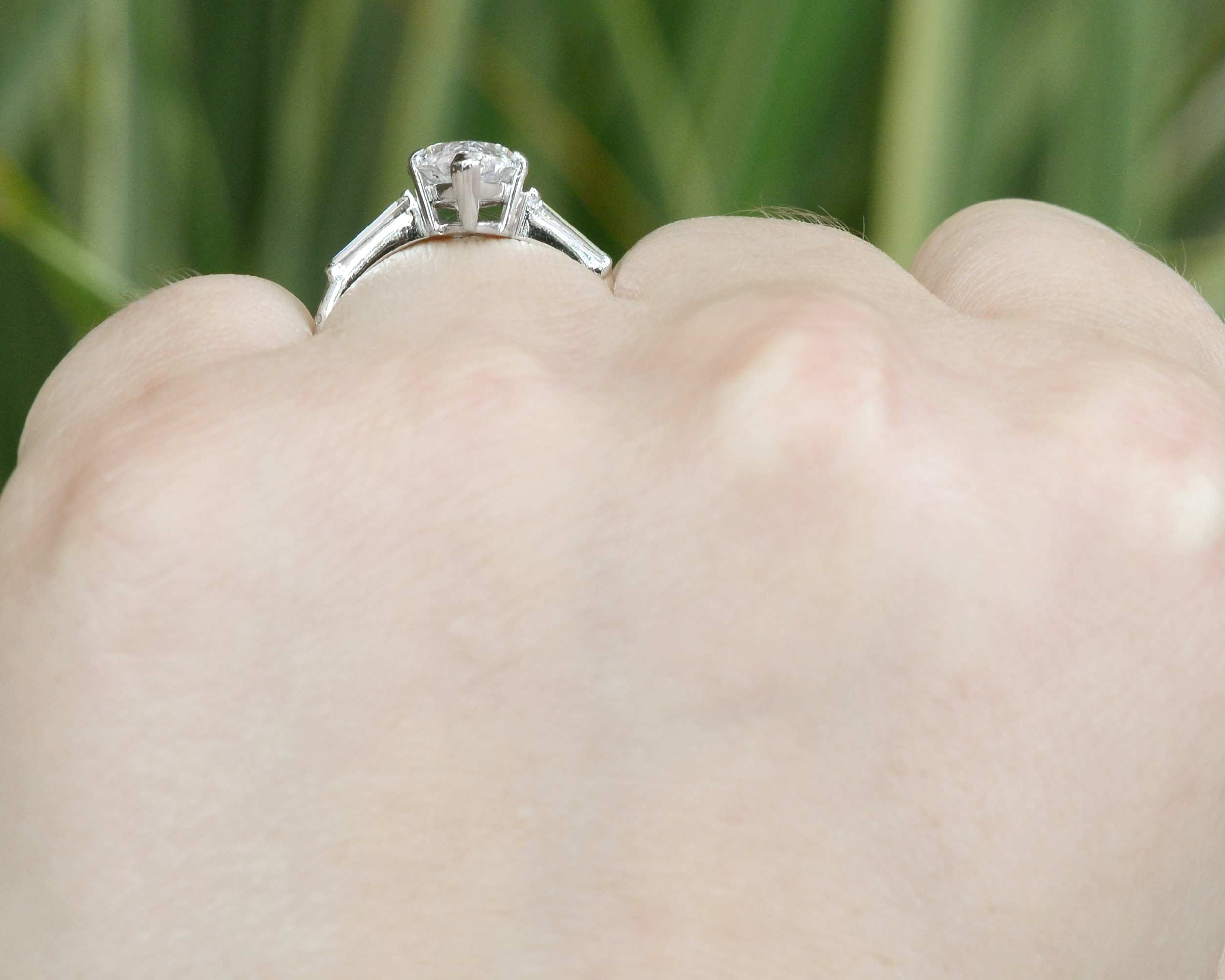 A boat shaped profile, 3 diamond engagement ring.