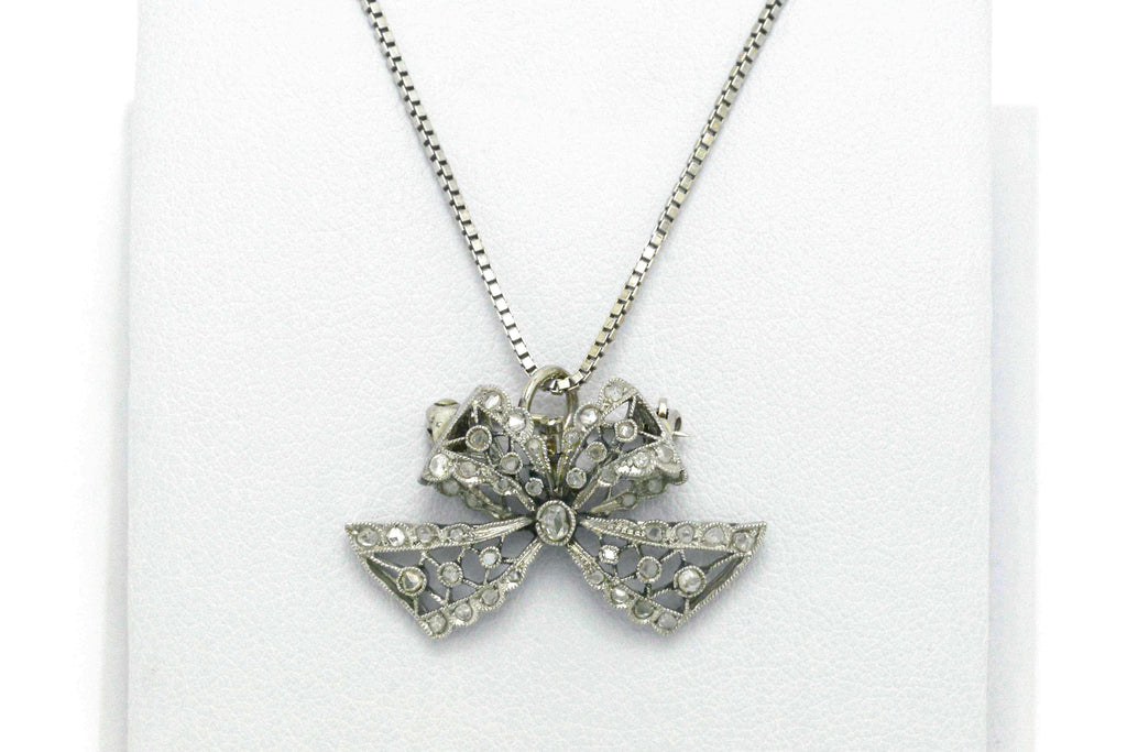 An antique Edwardian diamond bow platinum necklace.