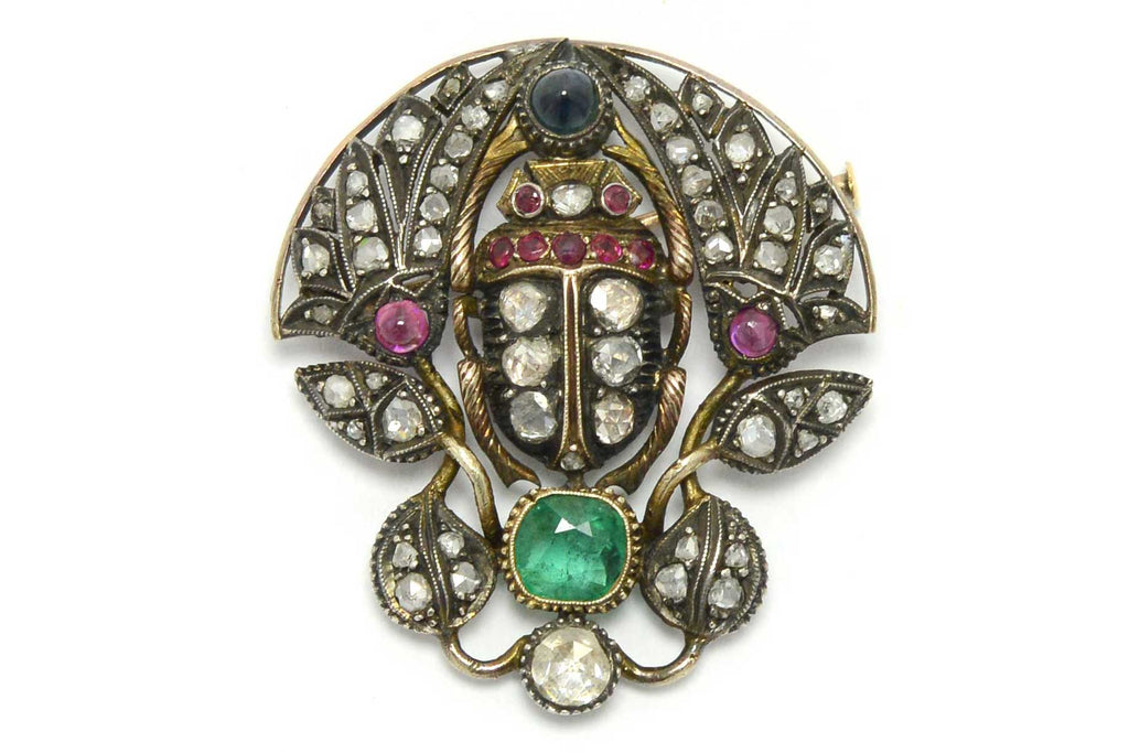 A late 1800s Victorian brooch with a variety of gemstones and diamonds.