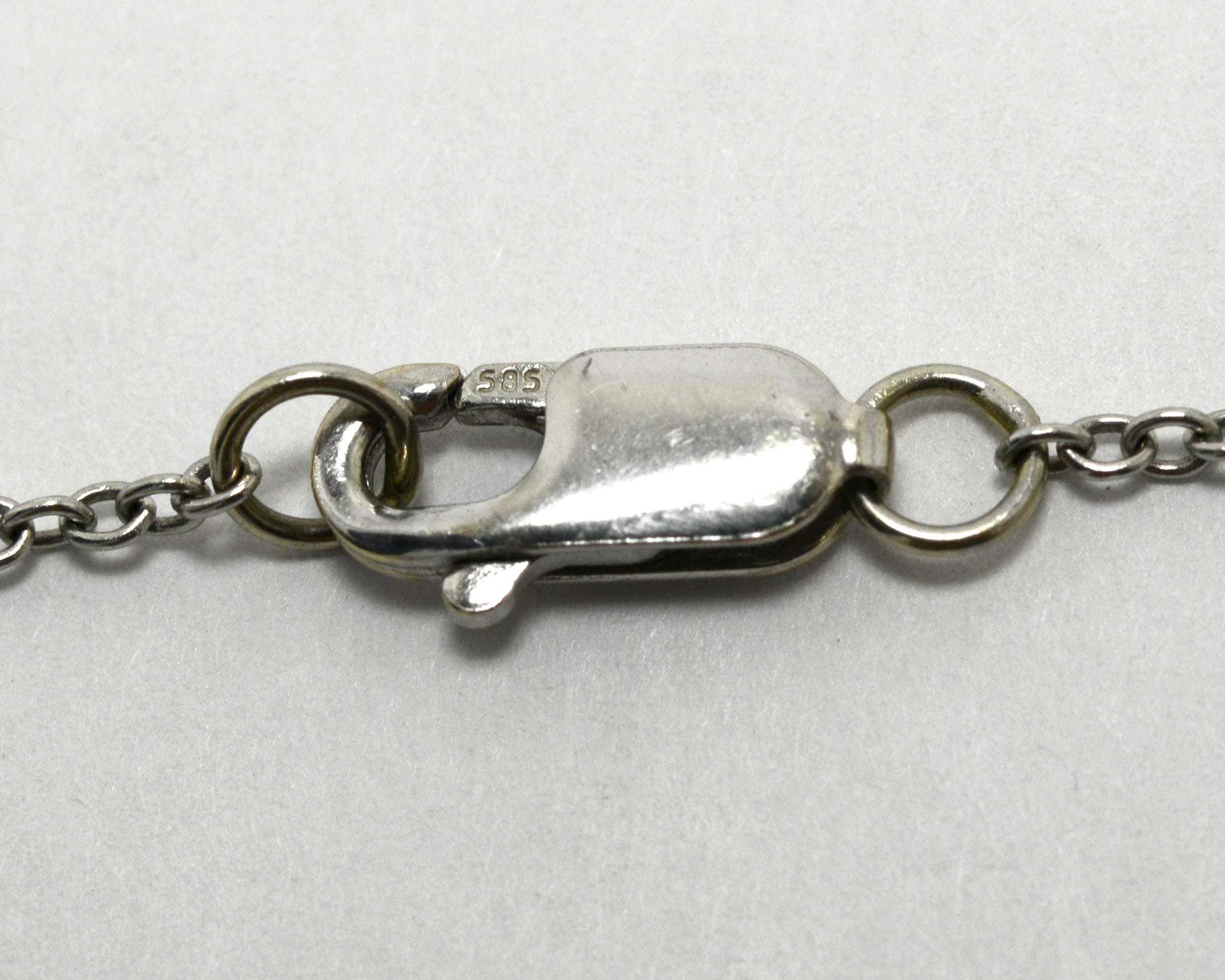 An antique platinum necklace with a spring clasp fastening.