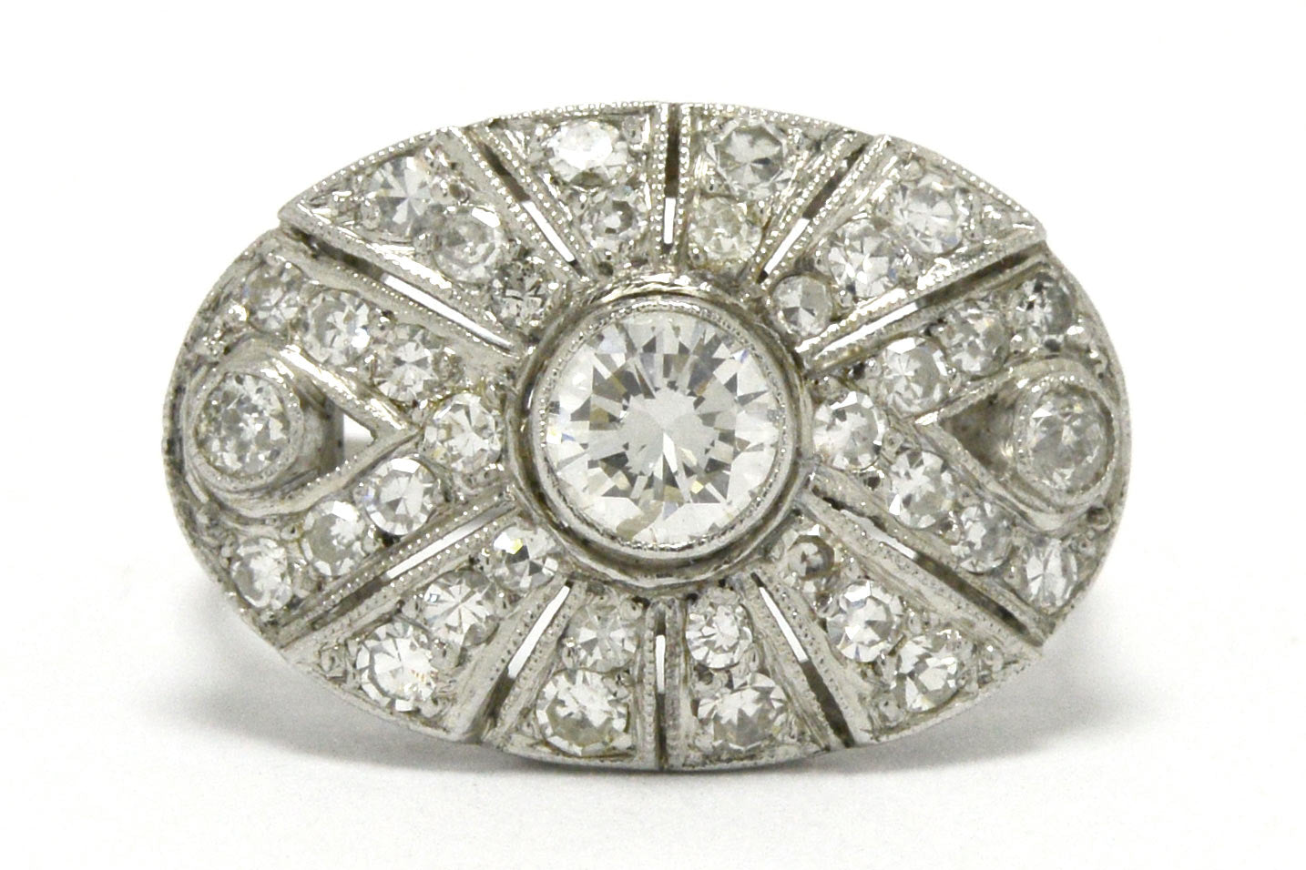 An oval Art Deco statement ring with a transitional round brilliant diamond.