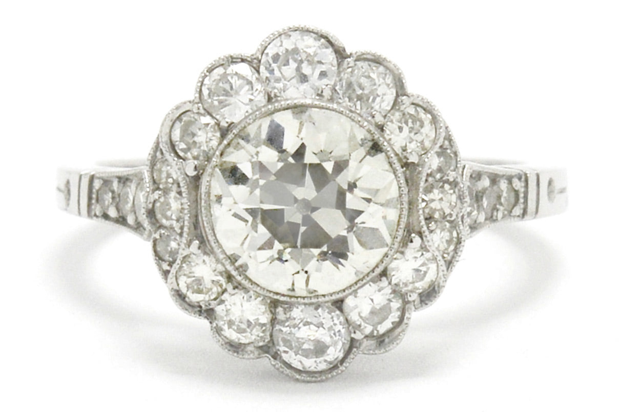 This old European cut diamond cluster engagement ring looks like a flower.