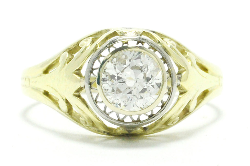 A 14k gold antique old mine brilliant diamond illusion engagement ring.