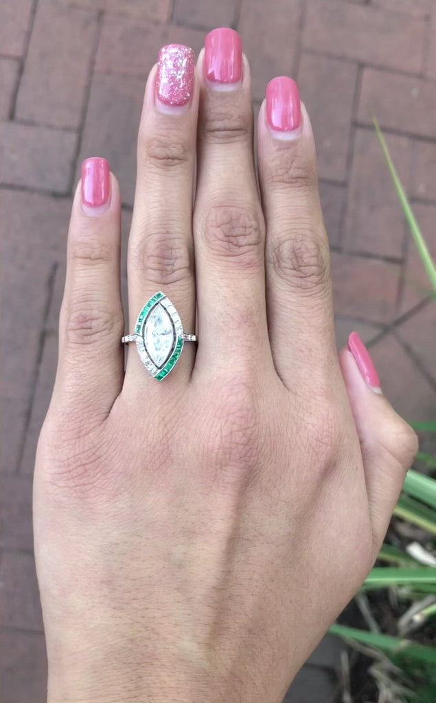 This navette shaped emerald and diamond target ring resembles a little boat.