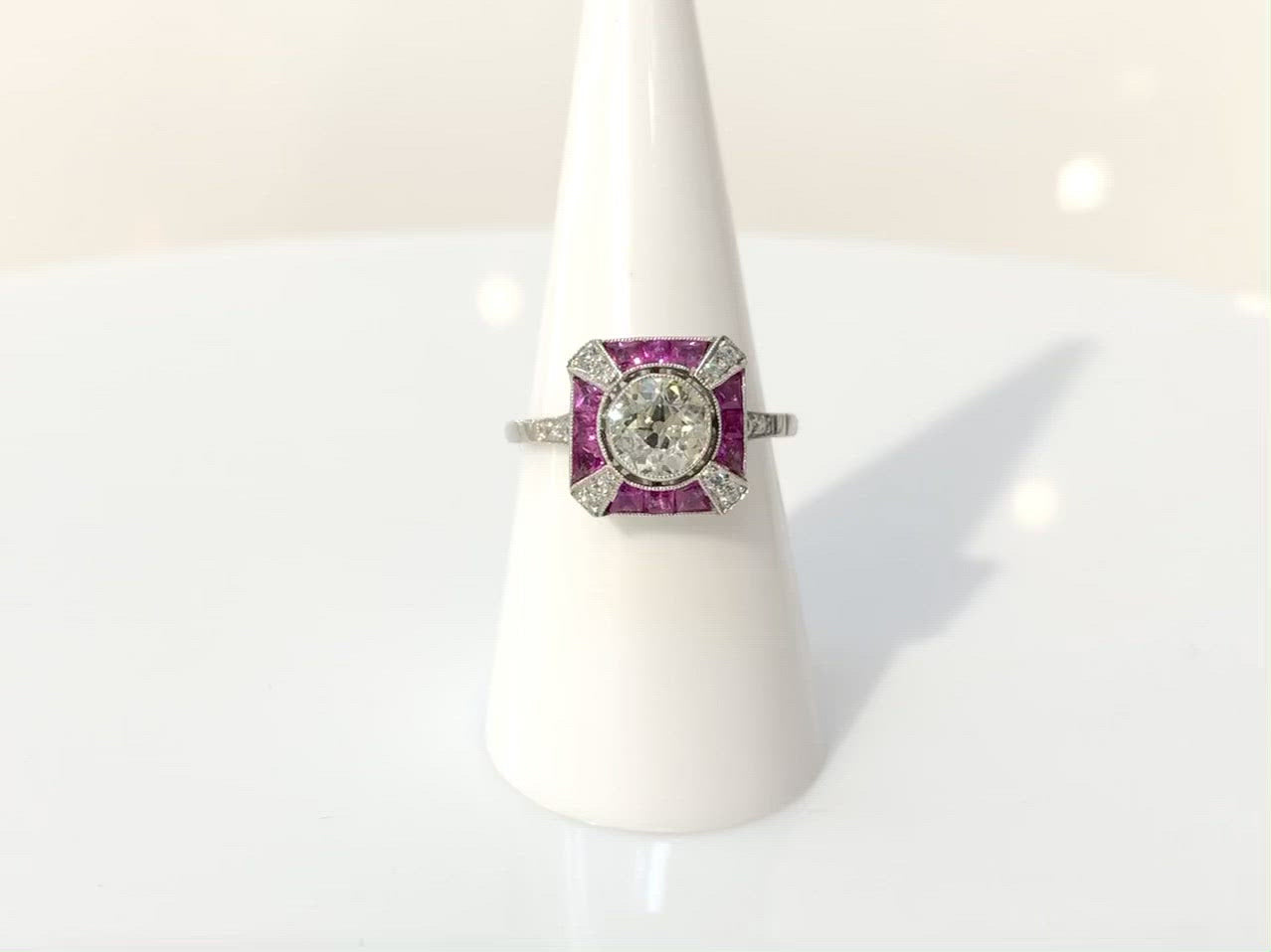 An x design, diamond and ruby platinum wedding ring.