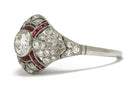 A bezel set round brilliant diamond wedding ring with ruby stripes.