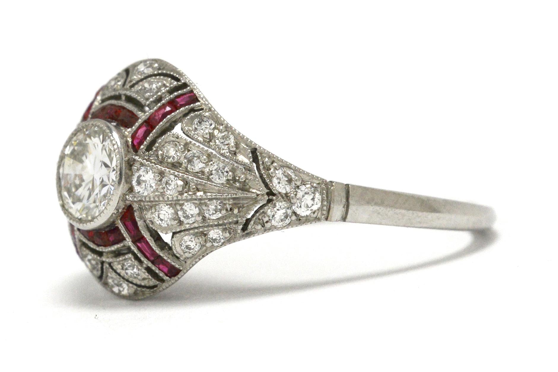 A bezel set round brilliant diamond wedding ring with ruby stripes.
