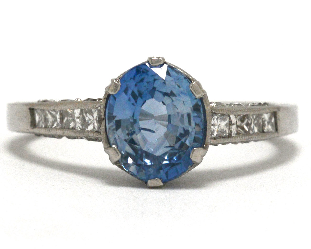 Art Deco inspired ceylon sapphire solitaire engagement ring with diamonds.