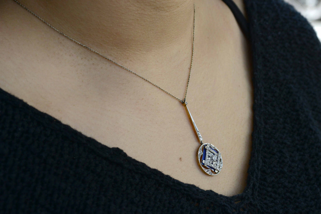 Blue enamel accents this square, geometric diamond pendant necklace.