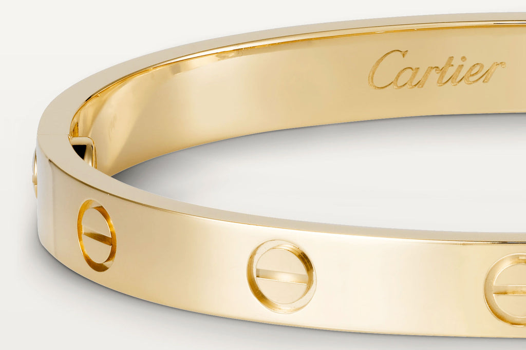 An authentic 18k gold love bracelet with the Cartier hallmark engraving.
