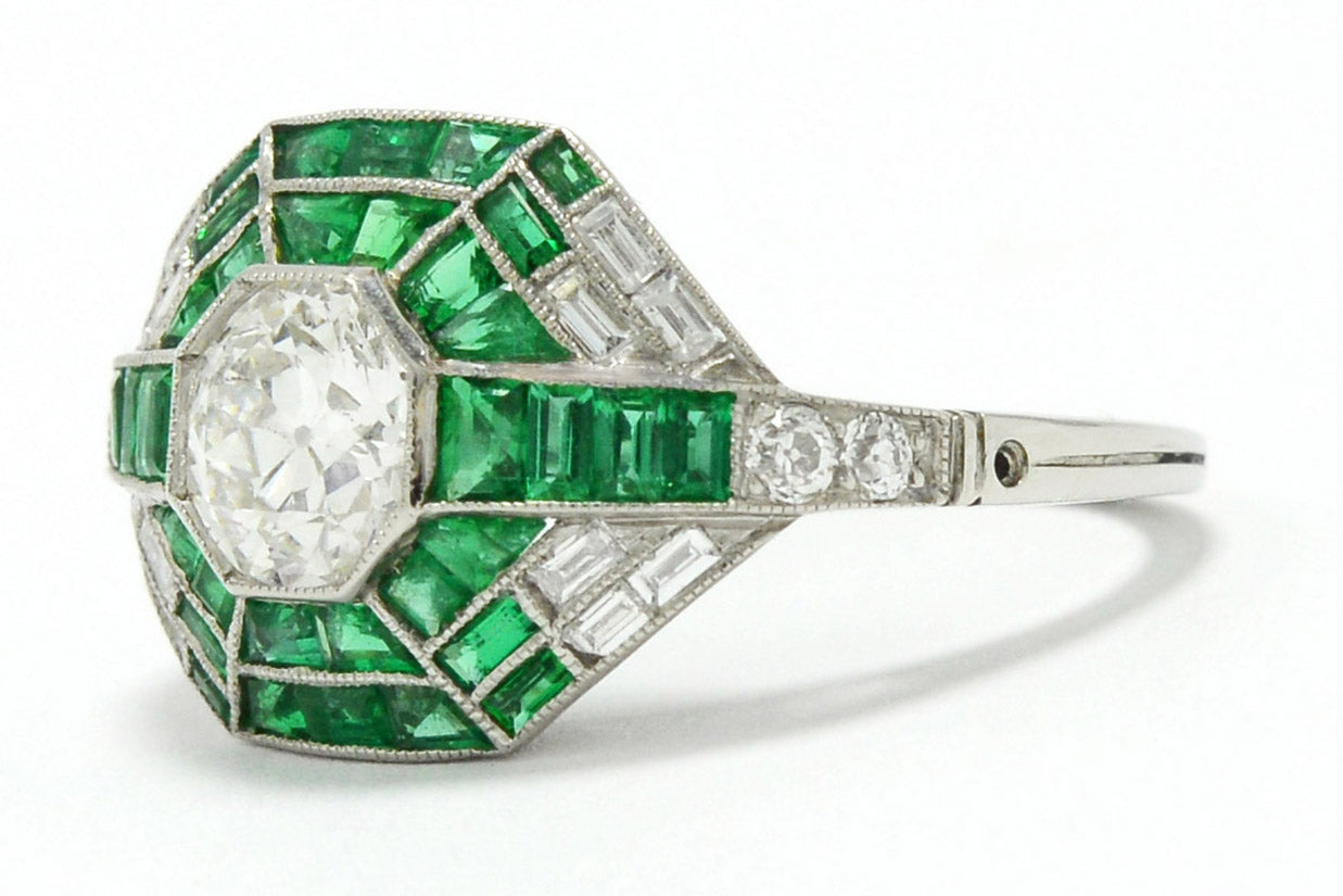 A unique platinum diamond mosaic engagement ring with diamonds and bright green emeralds.