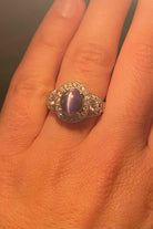 Under incandescent lighting this oval cabochon alexandrite looks gray-purple.