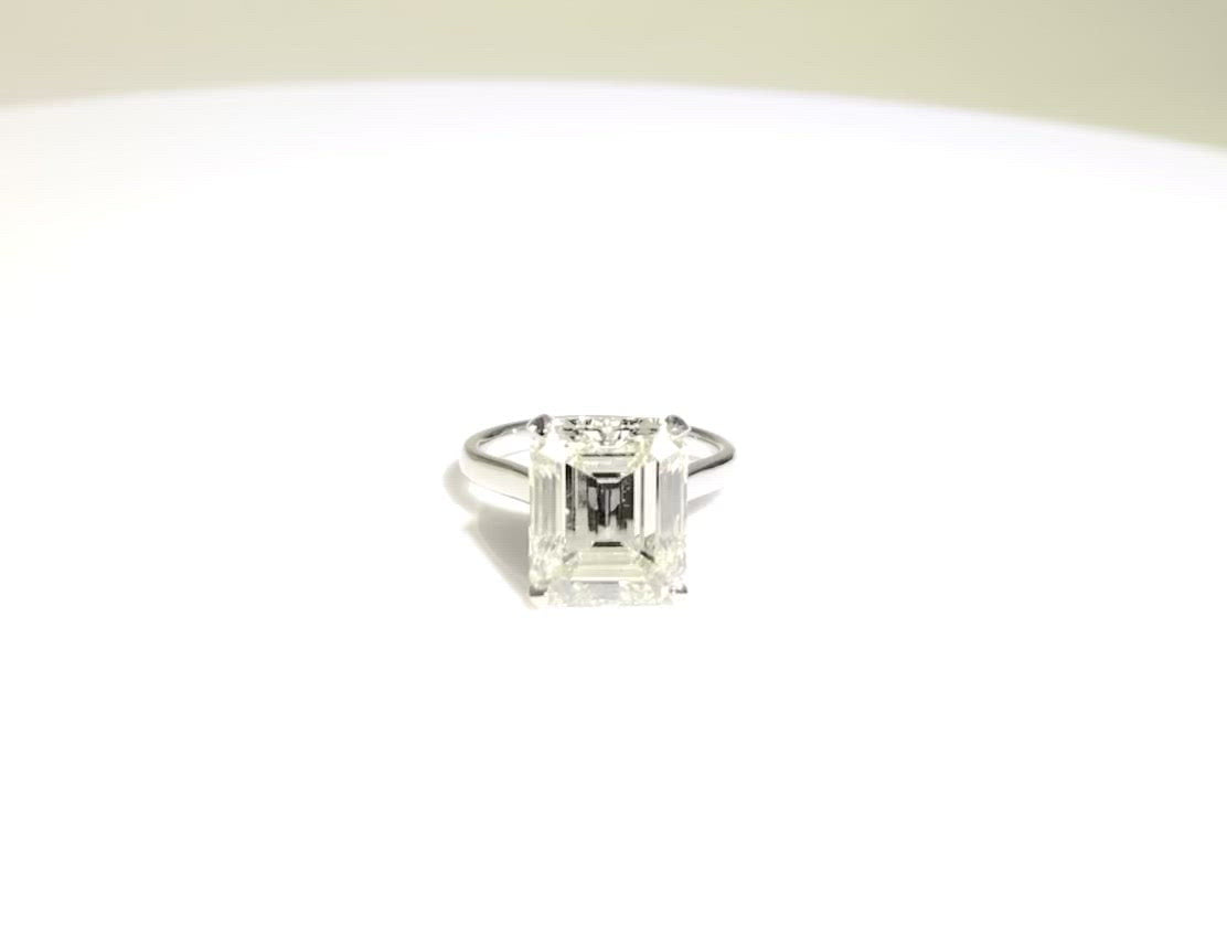 An 8 carat emerald cut diamond solitaire engagement ring.