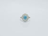 This large, five carat blue zircon is surrounded 2 halos of diamonds.