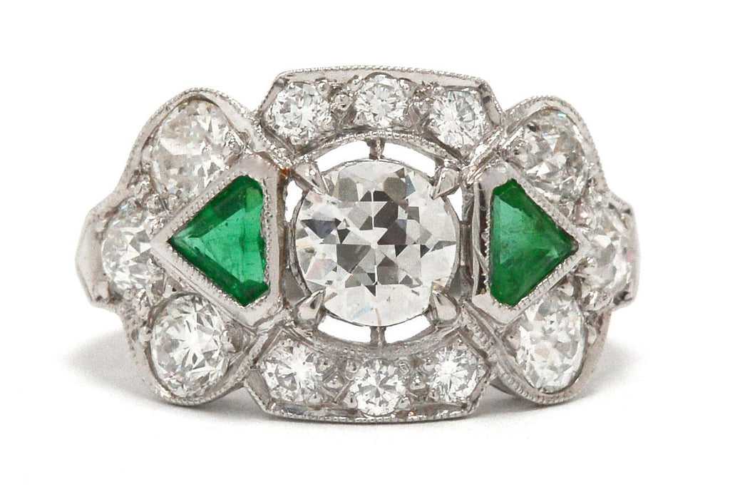 Old European brilliant diamond engagement ring with emeralds.
