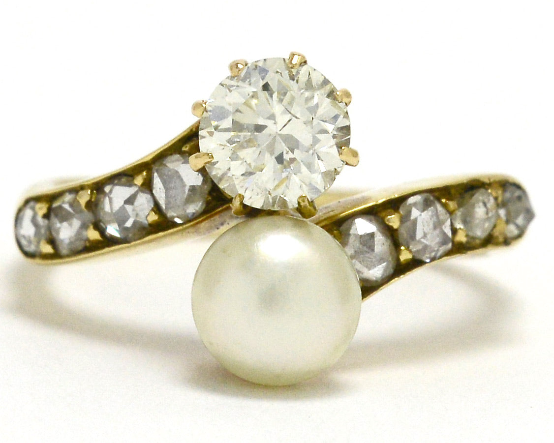 A 2 stone pearl and diamonds solitaire engagement ring.