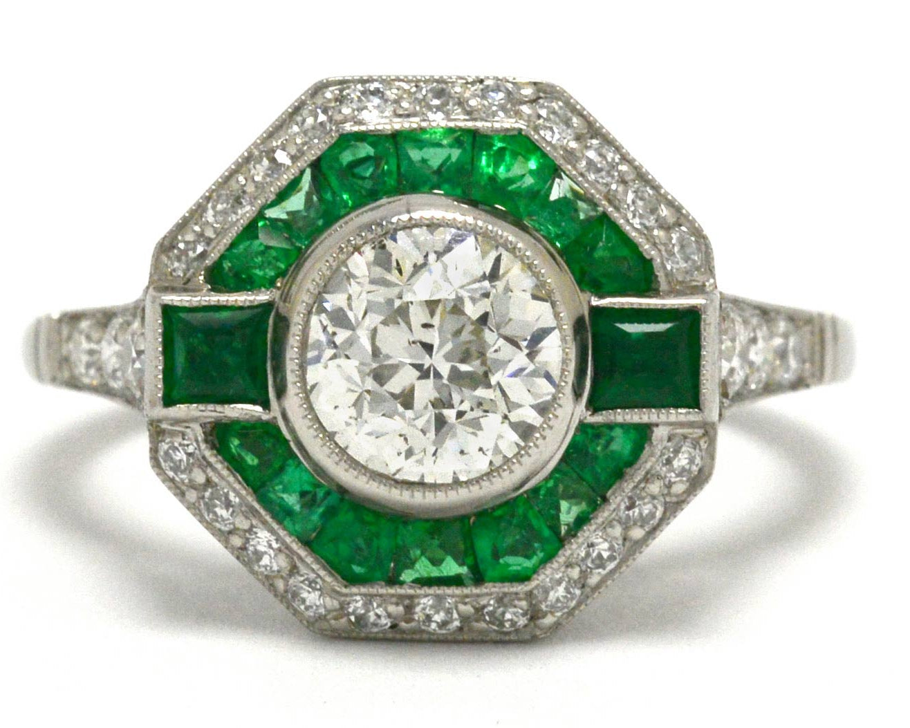 A unique octagon Art Deco diamond engagement ring with an emerald halo.