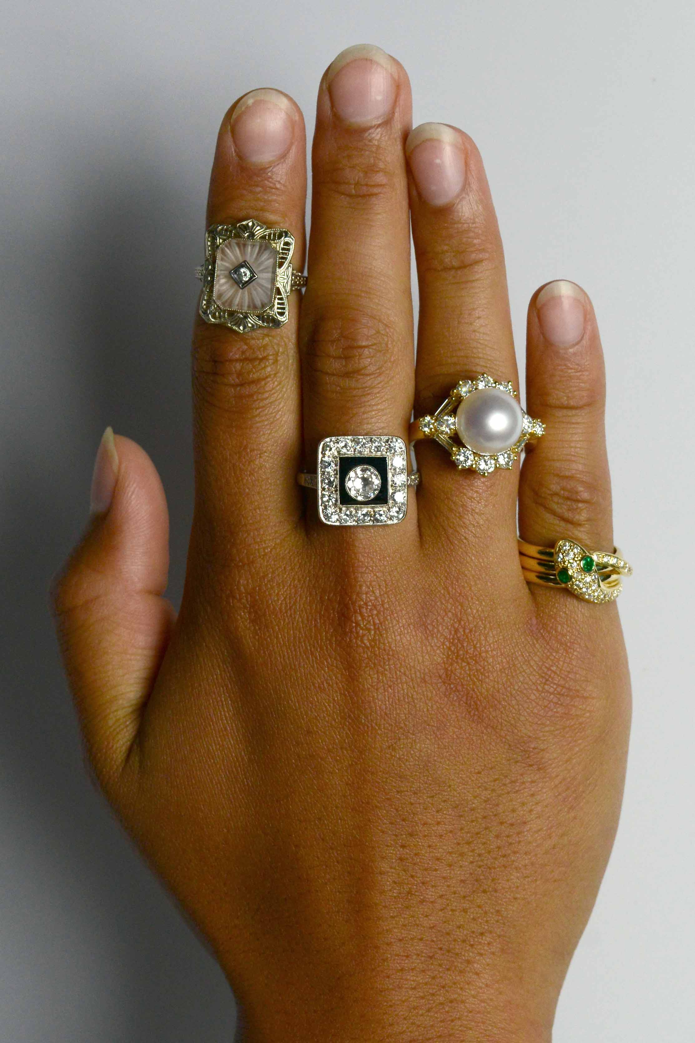 A collection of unique gem and diamond halo statement rings.