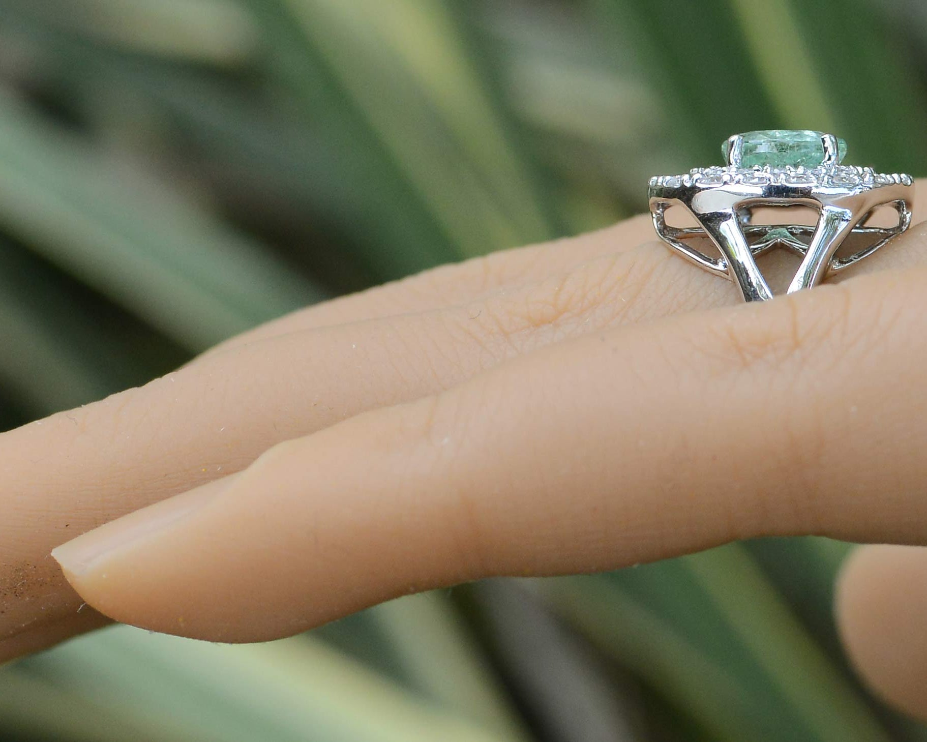 A new, contemporary paraiba tourmaline engagement ring with a double diamond halo.