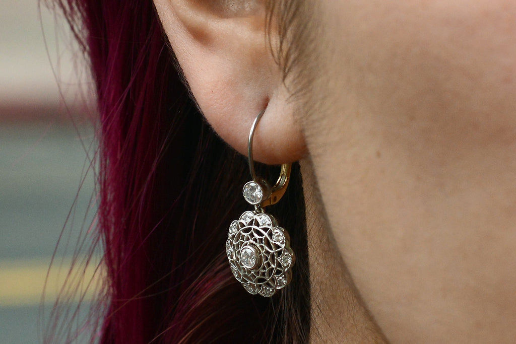 A webbed filigree design of earrings that resembles snowflakes.
